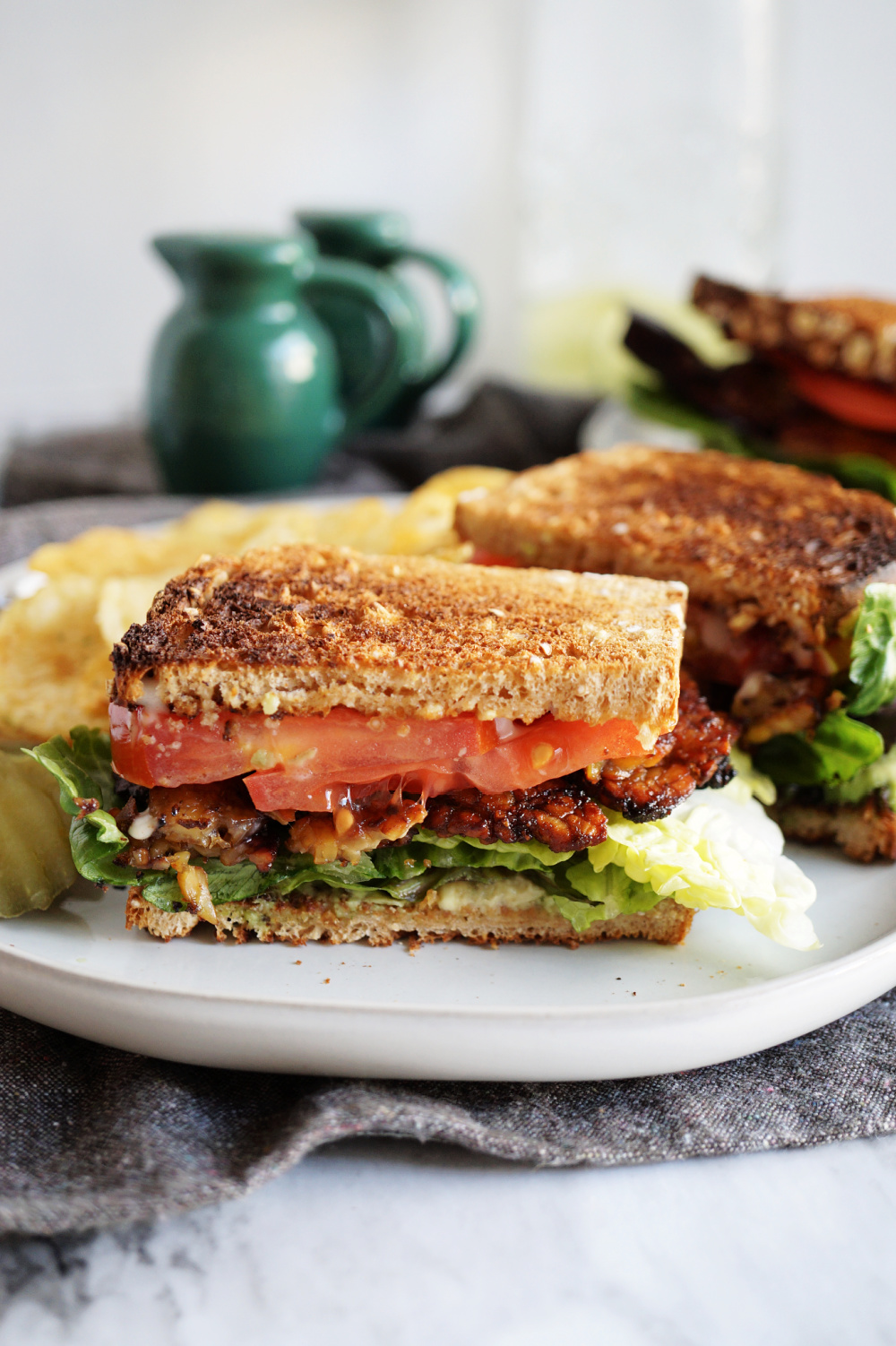 BLT sandwich cut in half on white plate