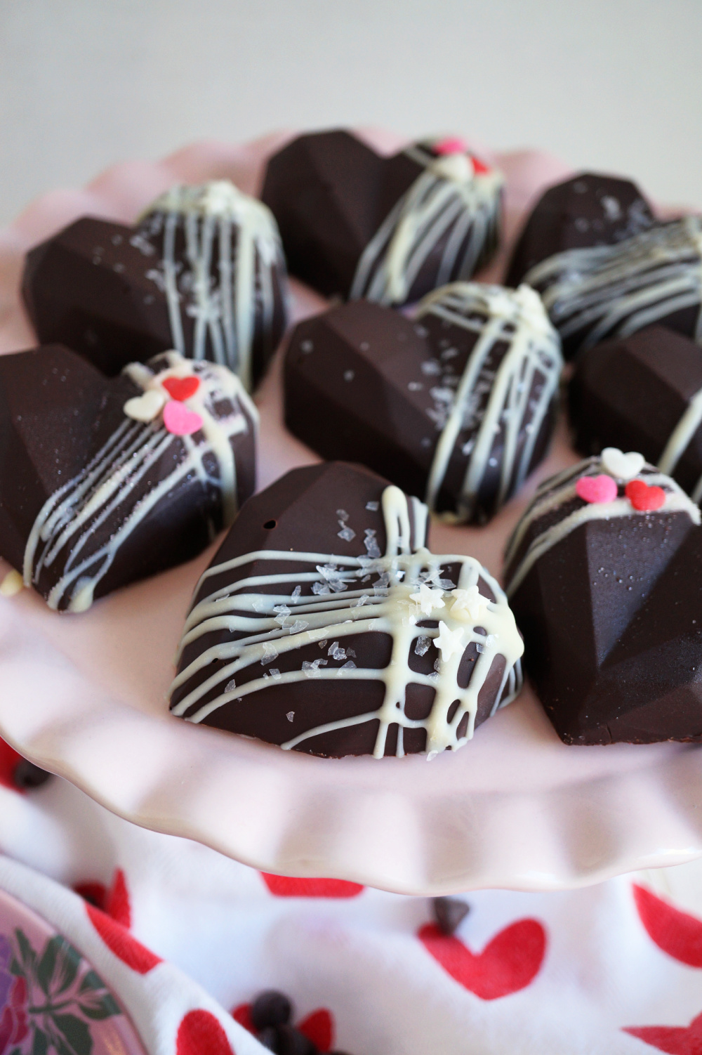 heart shaped chocolates on pink cake stand