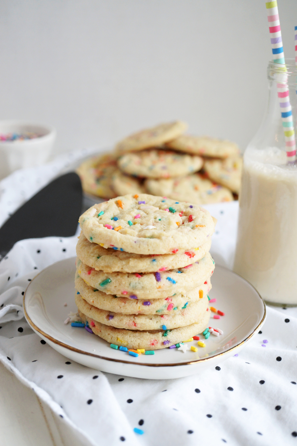 stack of confetti sugar cookies on white plate