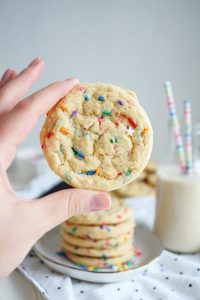 hand holding up a confetti cookie