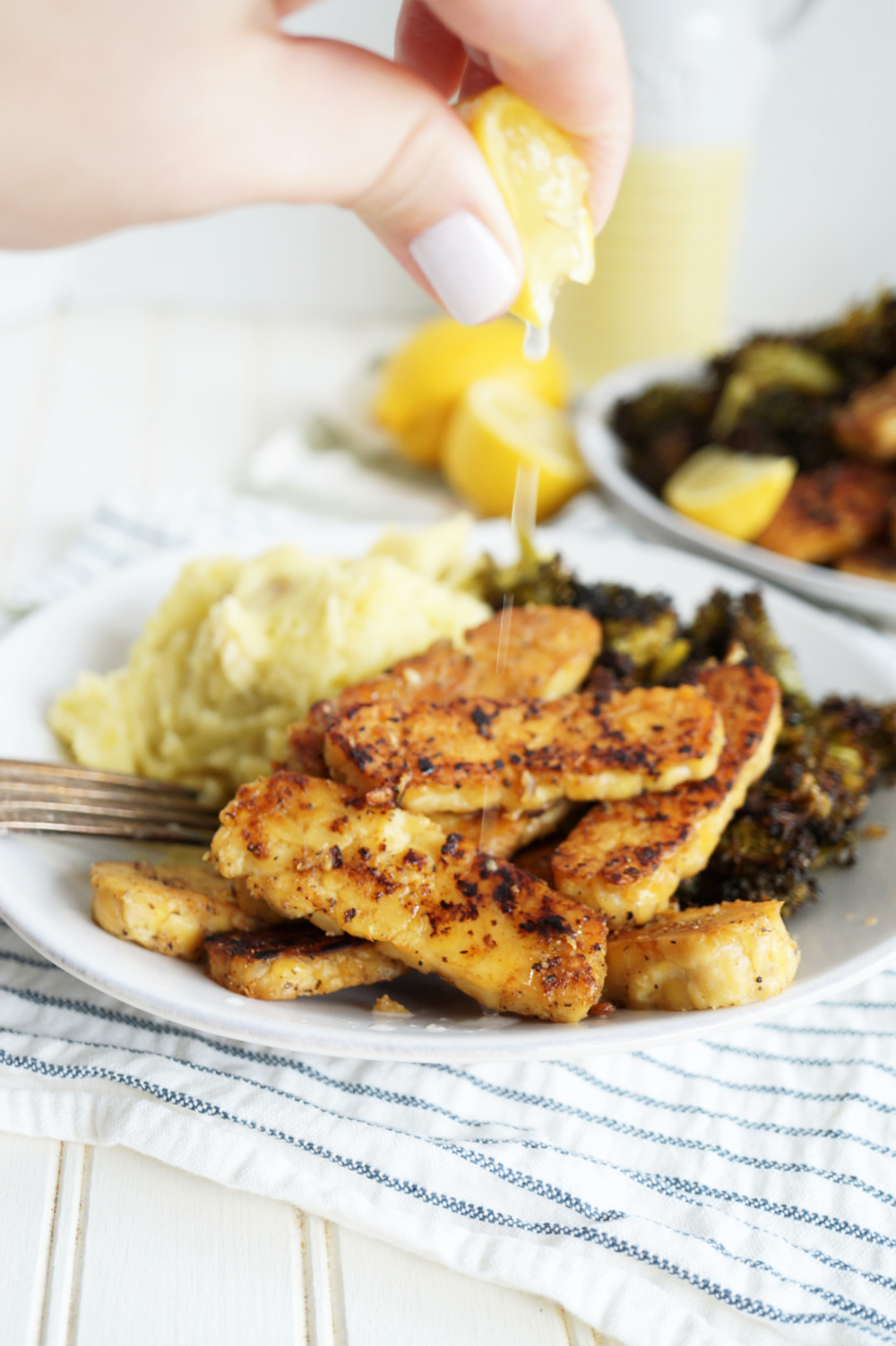 squeezing lemon on tempeh