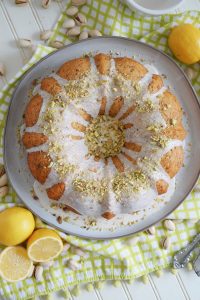 overhead photo of lemon pistachio bundt cake with glaze and pistachios on top