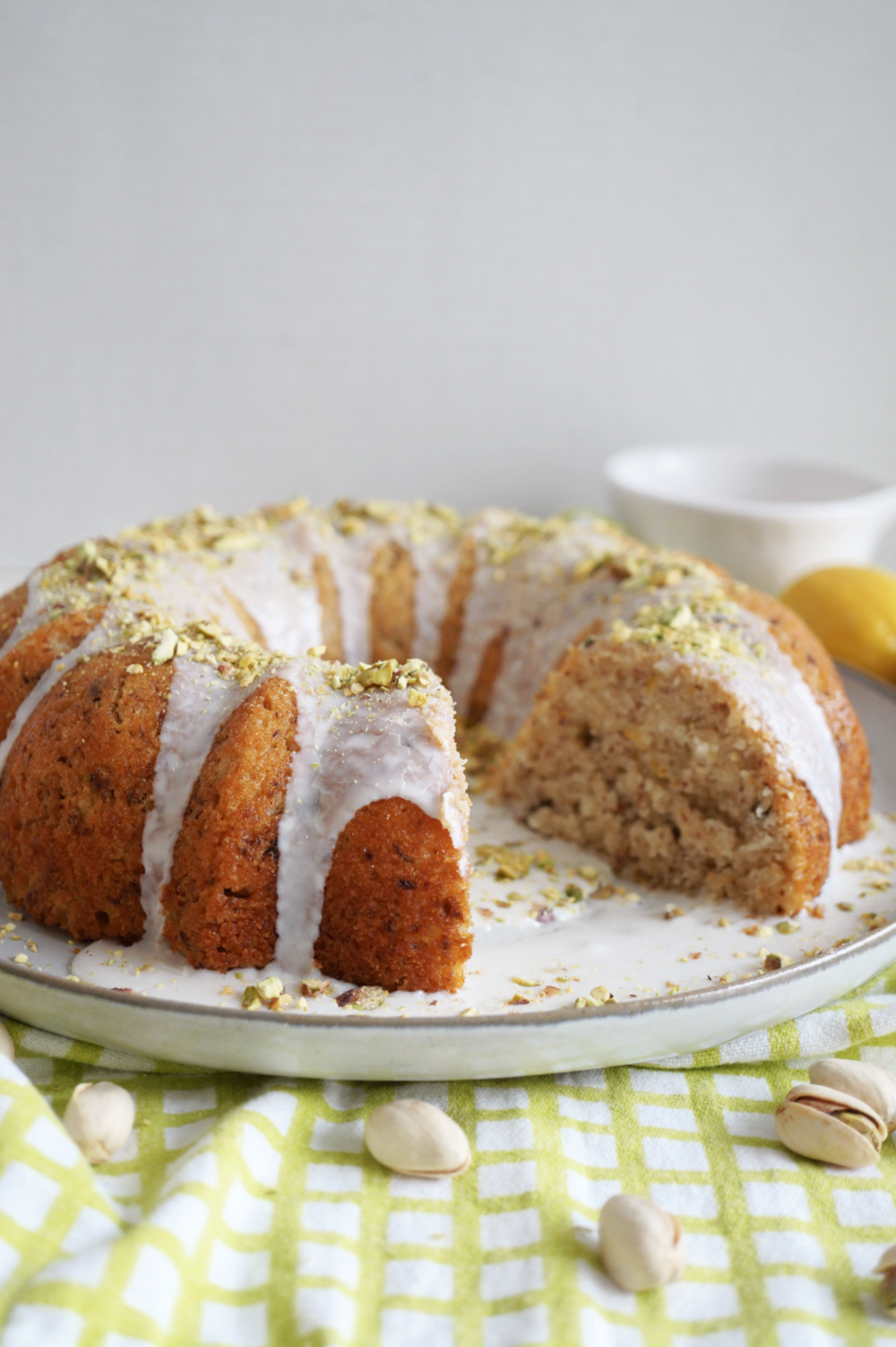 lemon pistachio cake with slice cut out