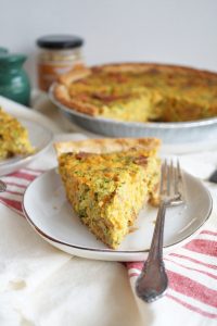 slice of broccoli cheese quiche on plate