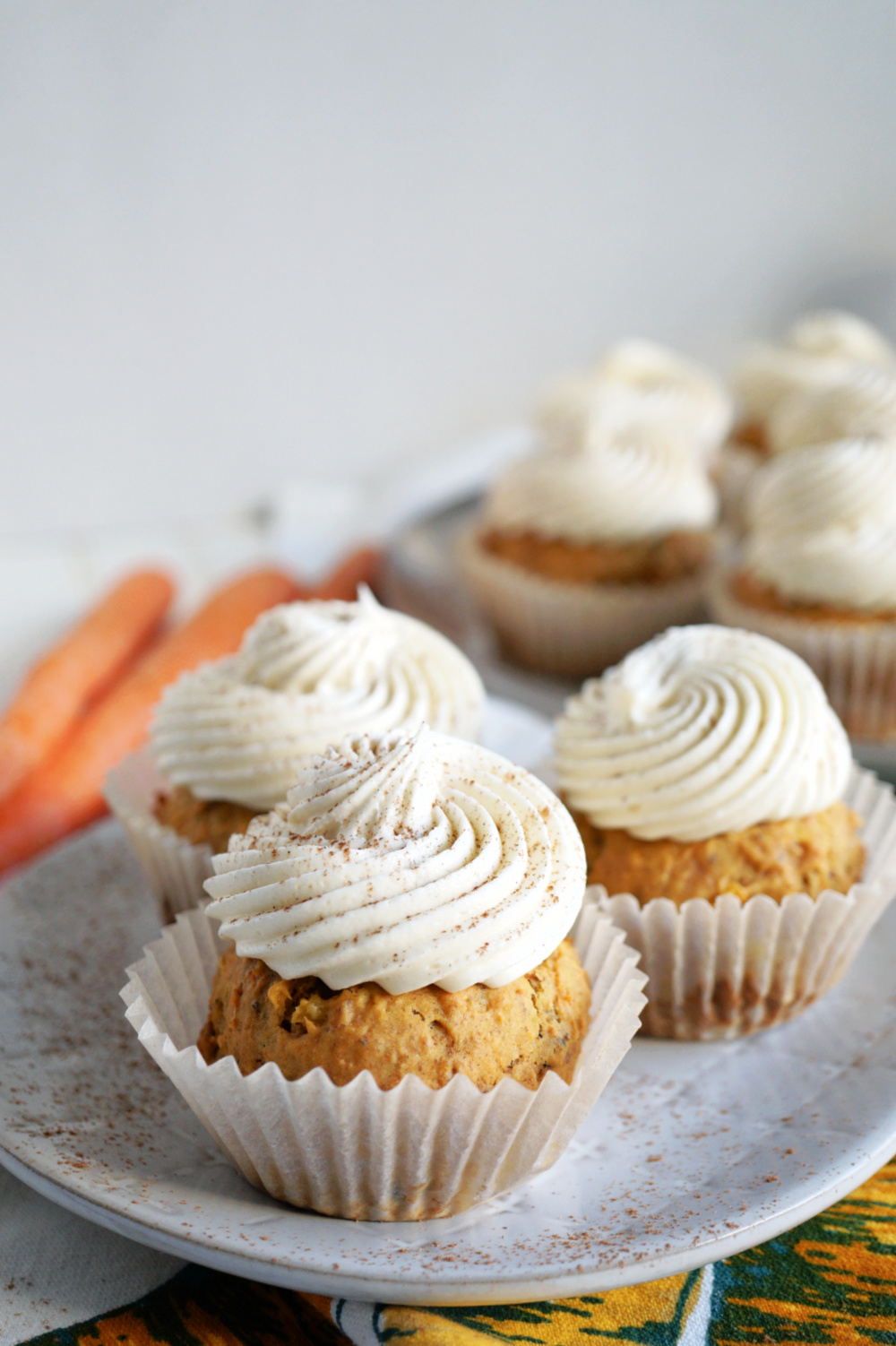 carrot cake cupcakes with white frosting on top