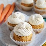 three carrot cupcakes on plate