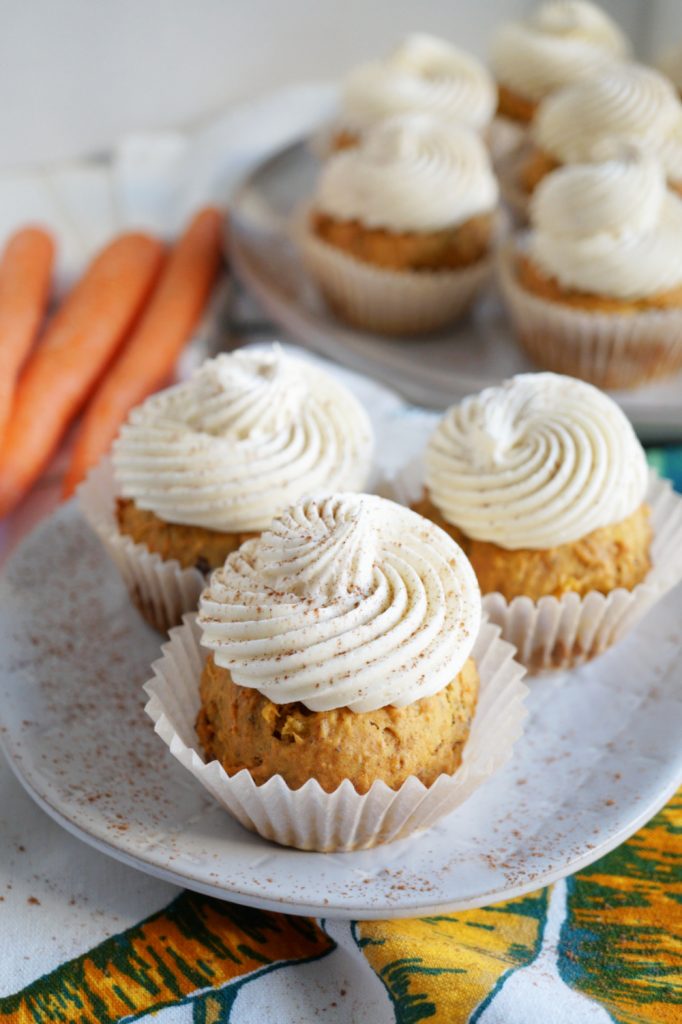 three carrot cupcakes on plate