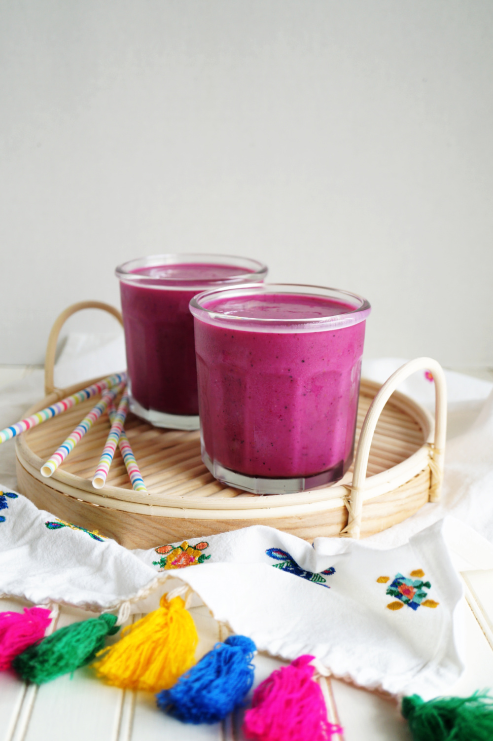 two glasses of pink pitaya smoothie on tray