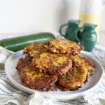 pile of golden brown cheesy zucchini fritters