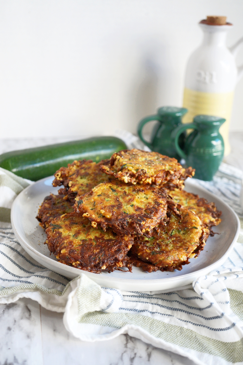 pile of golden brown cheesy zucchini fritters