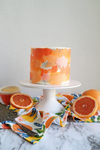 grapefruit poppyseed cake on stand