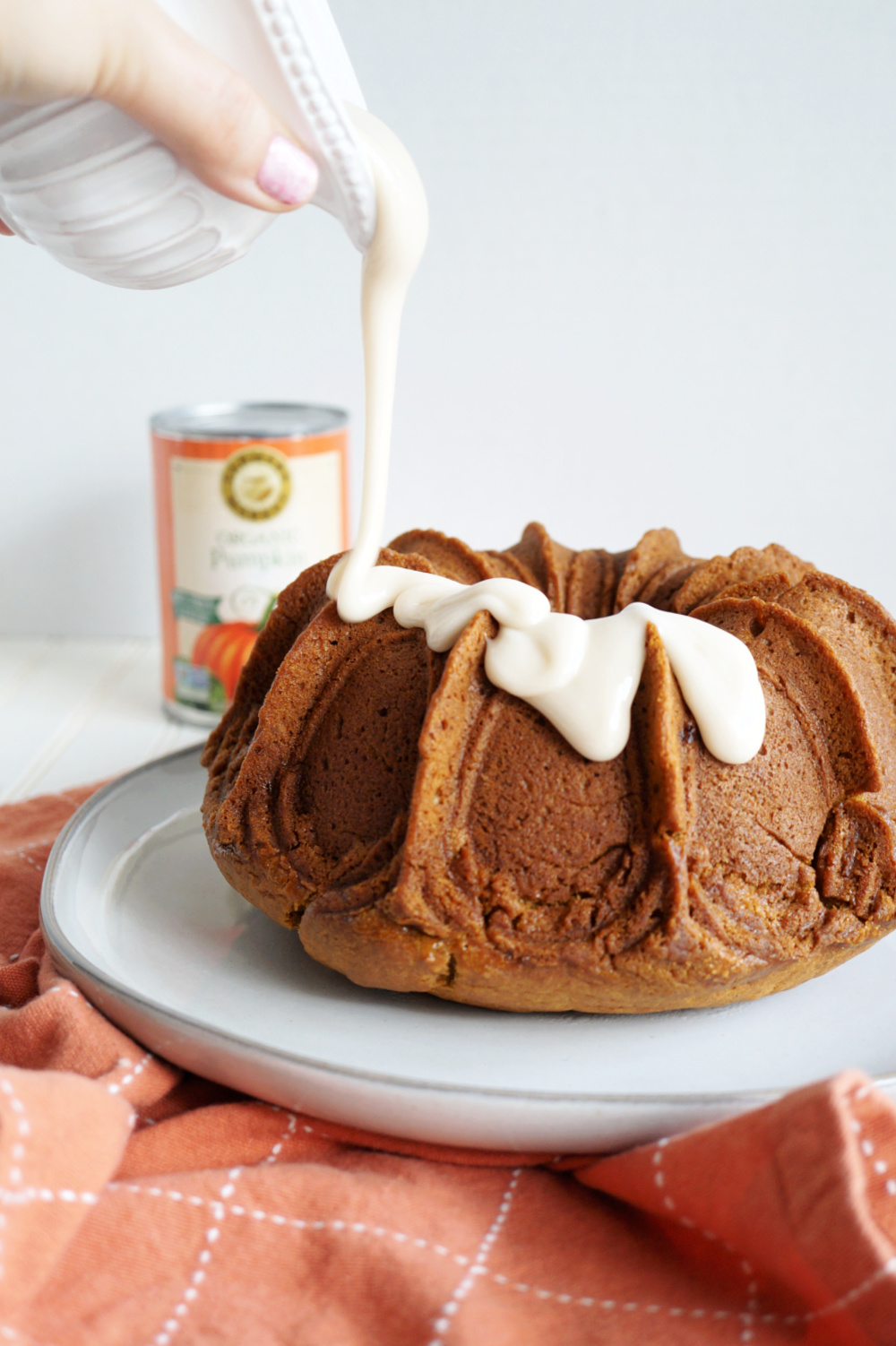 pouring glaze on pumpkin cake