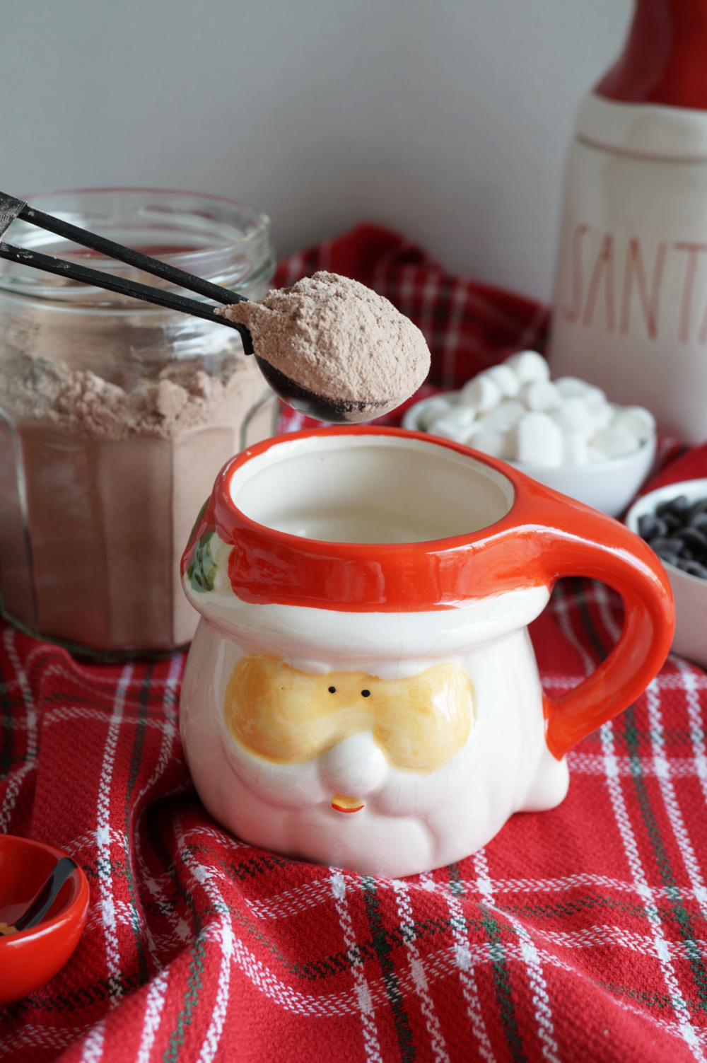 pouring hot cocoa mix into mug