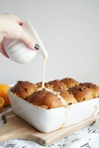 pouring glaze on top of buns