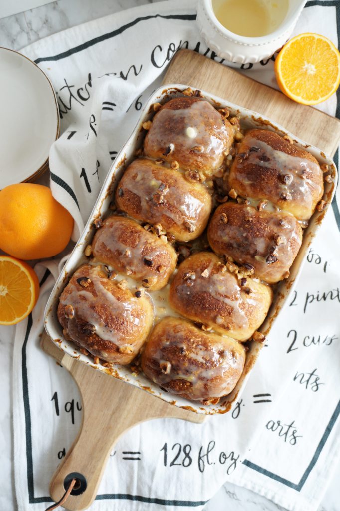 overhead photo of a pan of glazed orange buns